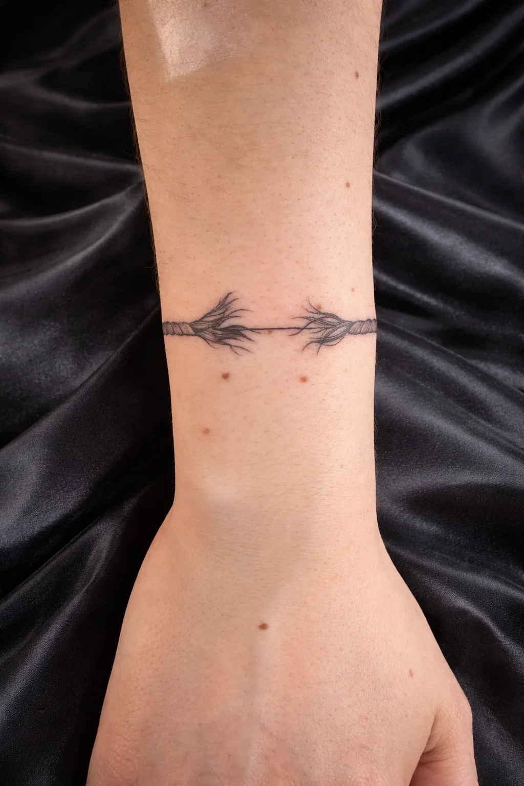 Fine line bracelet tattoo