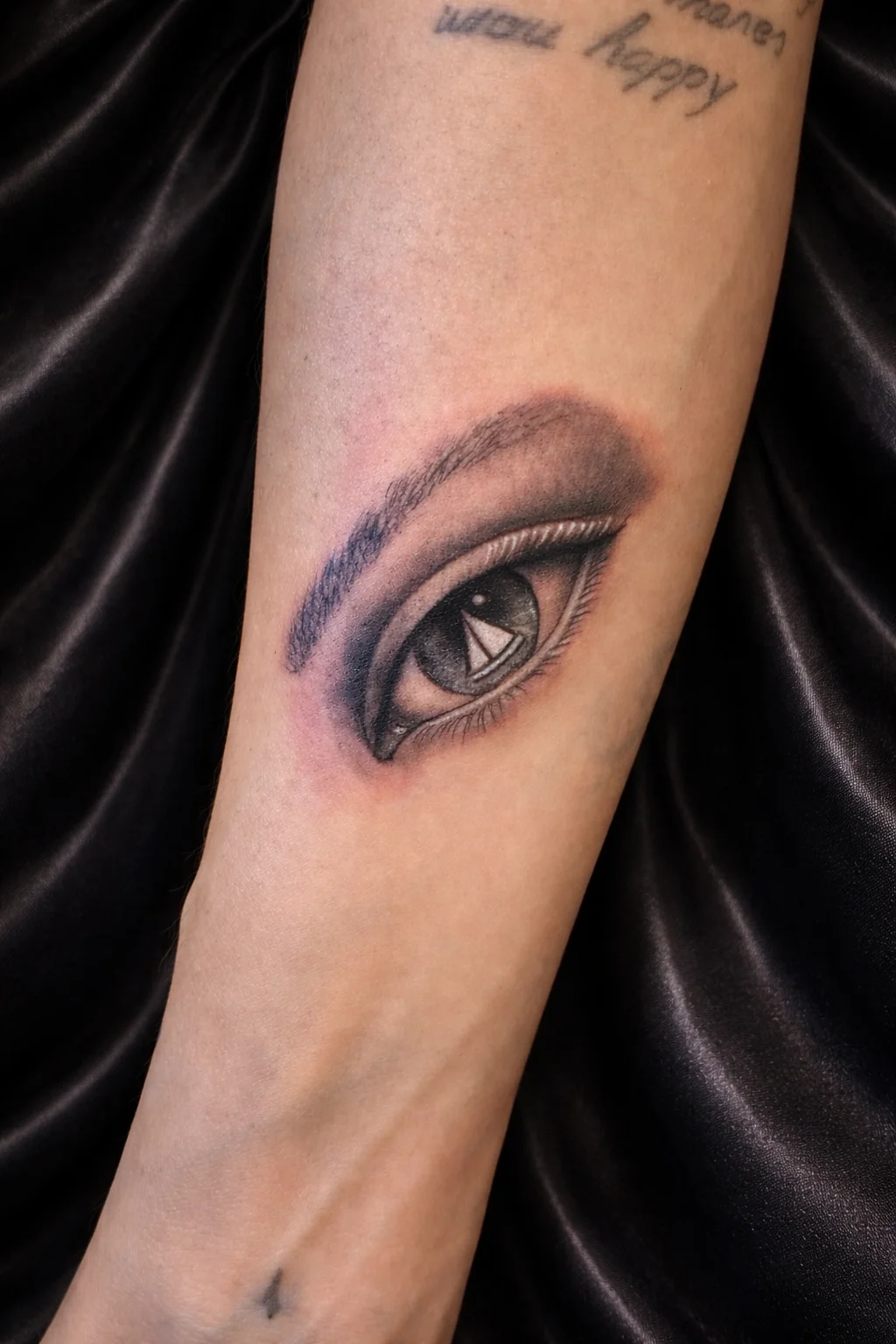 Eye with lettering tattoo